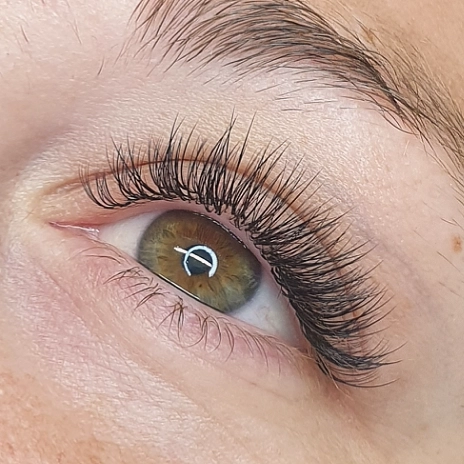 Lash extensions on a green eye, close up